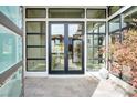 Modern double doors framed by glass windows, providing a bright and airy entryway at 32 Hunting Horn Dr, Las Vegas, NV 89135