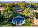 Backyard featuring a T-shaped pool, a covered outdoor kitchen, and well-maintained landscaping at 330 Rancho Cir, Las Vegas, NV 89107