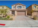 Charming two-story home features a desert landscape, stone accents, and a spacious driveway leading to a two-car garage at 4138 Bayley Skye Ave, Las Vegas, NV 89141