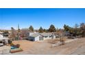 Wide view of the single-story home with a metal roof, spacious yard, and partial fencing at 432 Bonelli Ave, Overton, NV 89040