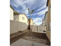 Spacious backyard area is surrounded by a fence and features a young palm tree at 4356 Pittsfield St, Las Vegas, NV 89115