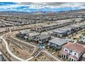 An aerial view of a modern home with a desert landscape and mountain views at 500 Pear Lake St, Las Vegas, NV 89138