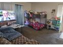 Functional bedroom featuring a bunk bed, comfortable seating and a large television at 5710 E Tropicana Ave # 1018, Las Vegas, NV 89122