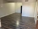 A bright and airy living room featuring stylish wood-look floors and neutral paint at 575 S Royal Crest Cir # 13, Las Vegas, NV 89169