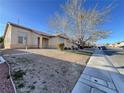 Lovely single story home with desert landscaping and a large tree in the front yard at 5829 Aqua Verde St, North Las Vegas, NV 89031