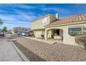 Inviting townhome exterior showcasing well-maintained landscaping, a desert rock yard, and a tile roof at 691 Anne Ln # 0, Henderson, NV 89015