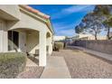 Side view of a lovely home with desert landscaping, a covered porch, and a charming seating area at 691 Anne Ln # 0, Henderson, NV 89015