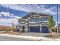 Two story Gathering home with gray paint, three-car garage and tastefully landscaped front yard at 7812 Alola Springs Ln # Lot 1, North Las Vegas, NV 89084