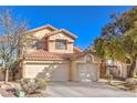 Well-maintained two-story home featuring a three-car garage and desert landscaping at 7848 Desert Bell Ave, Las Vegas, NV 89128