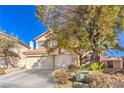 Two-story home with desert landscaping, a three-car garage, and a tile roof at 7848 Desert Bell Ave, Las Vegas, NV 89128