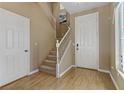 Welcoming entryway with hardwood floors, staircase, and neutral wall colors at 8235 Misty Sage St, Las Vegas, NV 89139