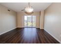 Bright living room featuring hardwood floors and sliding glass doors to balcony at 8255 Las Vegas Blvd # 415, Las Vegas, NV 89123