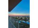 Balcony view showcasing a picturesque sunset, palm trees, and a sparkling pool at 8255 Las Vegas Blvd # 415, Las Vegas, NV 89123