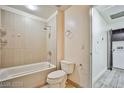 A bathroom featuring a tub/shower combo and a view of the laundry room at 8925 W Flamingo Rd # 110, Las Vegas, NV 89147