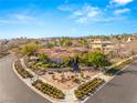 Stunning aerial view of single-Gathering home with a red tile roof and landscaped yard in a beautiful neighborhood at 9825 Glenrock Dr, Las Vegas, NV 89134