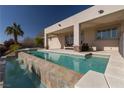 Relaxing backyard swimming pool with a covered patio, perfect for outdoor entertaining and enjoying the sun at 4830 Byzantine Ct, Las Vegas, NV 89149