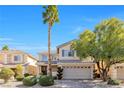 Inviting two-story home with a two-car garage and attractive landscaping at 11004 Dornoch Castle St, Las Vegas, NV 89141