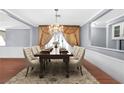 Formal dining room with hardwood floors, chandelier, and large table with seating for six at 1301 E St Louis Ave # C, Las Vegas, NV 89104