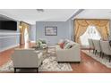 Elegant living room featuring stylish furniture, detailed window treatments and hardwood flooring at 1301 E St Louis Ave # C, Las Vegas, NV 89104