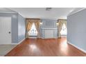 Living room with a decorative fireplace and light gray walls and hardwood floors at 1301 E St Louis Ave # C, Las Vegas, NV 89104