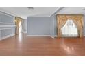 Bright living room featuring hardwood floors, custom wall trim and decorative window treatments at 1301 E St Louis Ave # C, Las Vegas, NV 89104