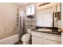 Bathroom featuring a shower-tub combination, toilet, and vanity with a granite countertop and white cabinets at 2115 Saint Paul Way, Las Vegas, NV 89104