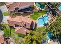 Aerial view of home with red tiled roof, pool, and well-maintained landscaping at 229 Drysdale Cir, Henderson, NV 89074