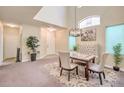 Charming dining area featuring high ceilings, elegant decor, and natural light at 2865 Vigilante Ct, North Las Vegas, NV 89081
