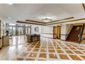Grand lobby with tile flooring, high ceilings, staircase, sitting area, and elegant decor at 30 Strada Di Villaggio # 143, Henderson, NV 89011