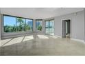 A bright living room with expansive windows and a sliding glass door with a city view at 322 Karen Ave # 201, Las Vegas, NV 89109