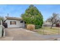 Single story home featuring white siding, a driveway and chain link fence at 343 W Basic Rd, Henderson, NV 89015