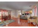 Spacious living area featuring shiny wood floors, neutral walls, and modern furniture at 4068 Pistachio Nut Ave, Las Vegas, NV 89115