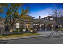 Charming home with a three-car garage and mature trees in the front yard at 420 Pinnacle Heights Ln, Las Vegas, NV 89144