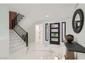 Inviting foyer featuring marble floors, modern staircase, and stylish decor for an upscale entrance at 4961 Tierra Del Sol Dr, Las Vegas, NV 89113