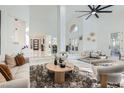 Bright, open living room with high ceilings, large windows, and elegant furnishings offering a comfortable space at 4961 Tierra Del Sol Dr, Las Vegas, NV 89113