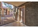 Front door with entry area featuring a metal railing and view of the adjacent building at 5009 Indian River Dr # 153, Las Vegas, NV 89103