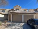Attractive townhome with a two-car garage and manicured shrubbery at 6104 Hillside Bloom Ct # 201, Las Vegas, NV 89130