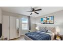 Staged bedroom with a plush bed, ceiling fan, and stylish decor at 6952 Midnight Bronze St, North Las Vegas, NV 89086