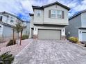 Charming two-story home with a stone-accented facade and well-manicured landscaping at 7708 Mojave Wind Ave, Las Vegas, NV 89113