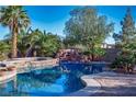 Backyard pool features a rock waterfall, spa, and lush landscaping, creating a private oasis at , Las Vegas, NV 89131