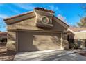 Frontal view of the garage, showcasing its textured doors and the architectural detail above, set against a clear blue sky at 8920 Litchfield Ave, Las Vegas, NV 89134