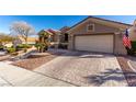 Spacious driveway leading to a two-car garage with a beautifully landscaped front yard at 10709 Brinkwood Ave, Las Vegas, NV 89134