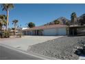 Charming single-story home with desert landscaping, an extra-wide driveway, and an attached three-car garage at 1108 Sidehill Way, Las Vegas, NV 89110