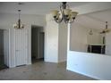 Open-concept living space featuring neutral paint, tile flooring, and a decorative fireplace at 1108 Sidehill Way, Las Vegas, NV 89110