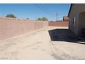 Spacious backyard with brick perimeter wall and potential for landscaping or outdoor living at 1580 S Outlaw St, Pahrump, NV 89060