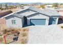 Charming single-story home with desert landscaping, three car garage, and gray exterior paint at 1580 S Outlaw St, Pahrump, NV 89060