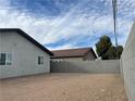 A large backyard features a block fence and a partial view of the neighboring home at 1838 Princeton St, North Las Vegas, NV 89030