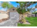 Well-kept home with attached garage, pristine lawn, mature trees, and inviting entrance for appeal at 2136 Velvet Hill Ave, Las Vegas, NV 89106