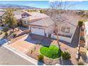 An elevated view of a well-maintained house showcasing the front yard and roof at 2633 Flare Star Dr, Henderson, NV 89044