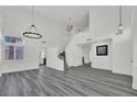 Open-concept living room with new gray flooring, spiral staircase, and ample natural light at 271 Francisco St, Henderson, NV 89014